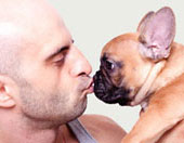 man kissing pet dog
